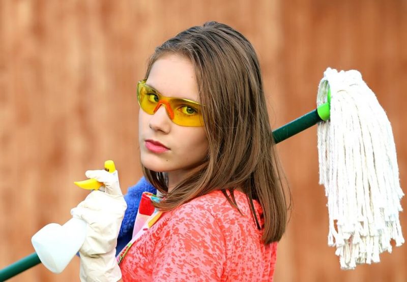 lady spraying and holding mop