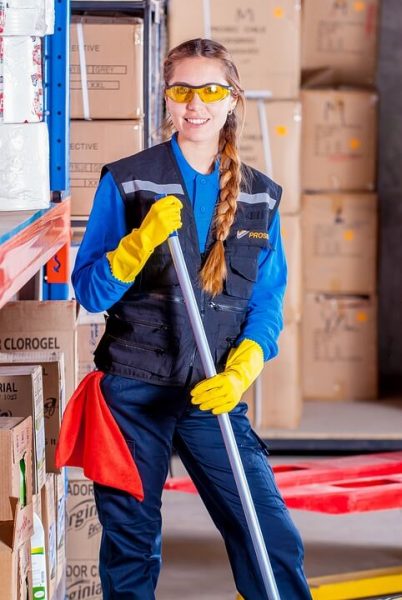 young lady standing with mop