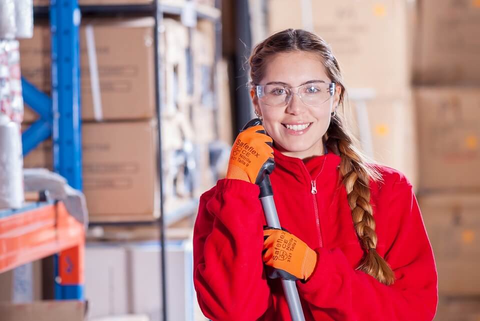 lady in red jumper holding a mop