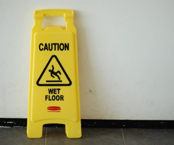 wet floor sign leaning on the wall