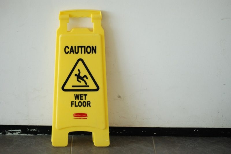 wet floor sign leaning on the wall