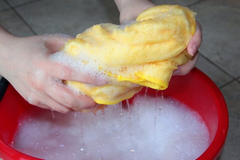 squeezing wet flannel in to a bucket